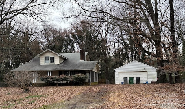 view of front of house featuring an outbuilding, a porch, and a garage