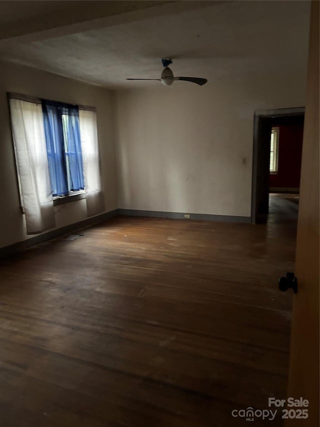 empty room with baseboards, ceiling fan, and hardwood / wood-style floors