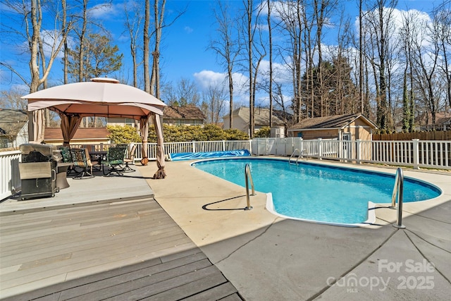 view of swimming pool with a fenced in pool, fence, and a gazebo