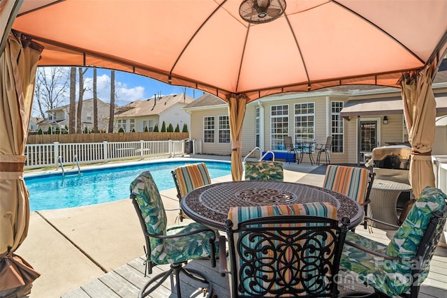 view of swimming pool with a residential view, fence, a fenced in pool, and a gazebo