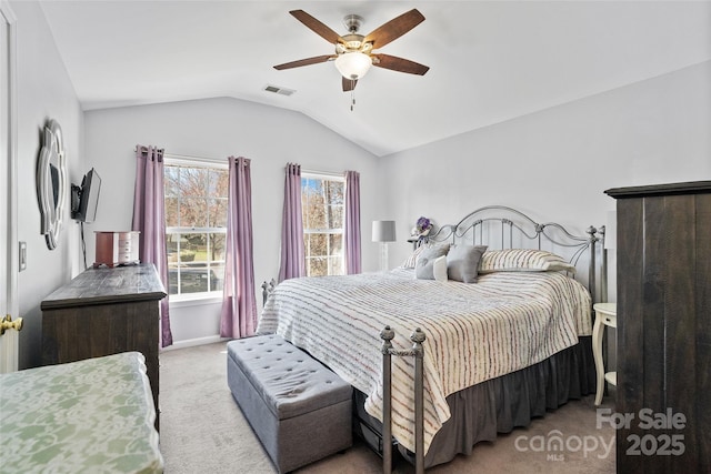 bedroom featuring light carpet, lofted ceiling, visible vents, and a ceiling fan