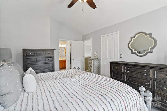 bedroom featuring lofted ceiling, ensuite bath, and ceiling fan