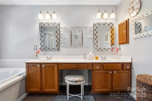 bathroom with double vanity, a sink, and a bath