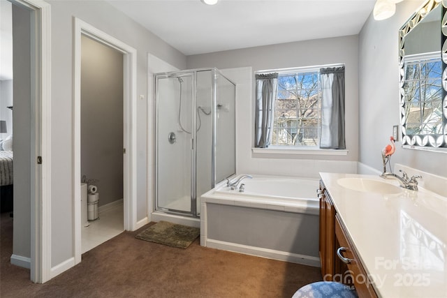 bathroom featuring carpet, a stall shower, vanity, baseboards, and a bath