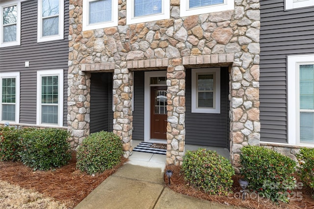 entrance to property with stone siding