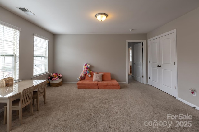 recreation room featuring carpet, visible vents, and baseboards