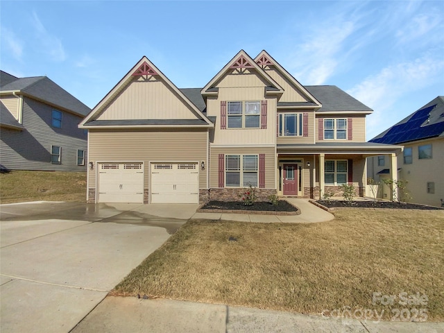 craftsman-style house with concrete driveway, covered porch, a garage, stone siding, and a front lawn