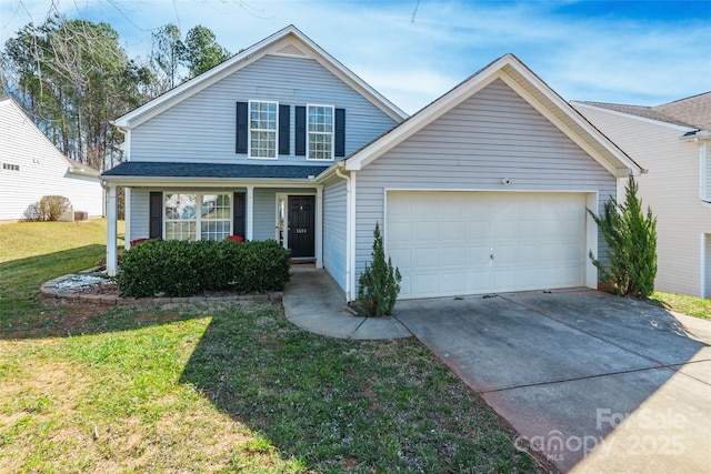 traditional home featuring an attached garage, driveway, and a front yard