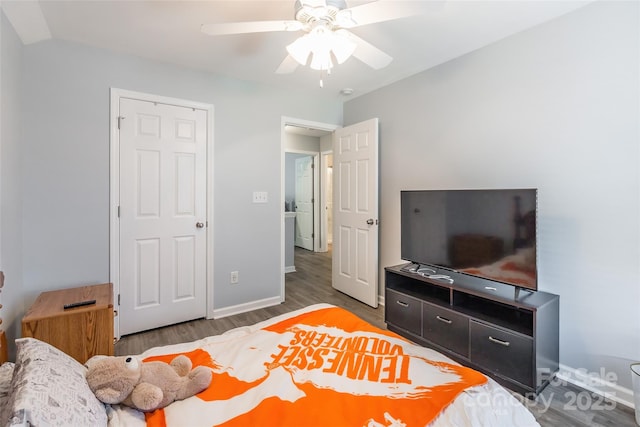 bedroom with a ceiling fan, baseboards, and wood finished floors