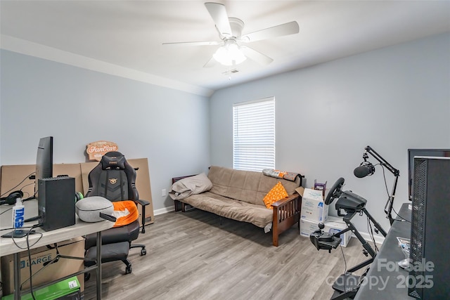 office with a ceiling fan, baseboards, visible vents, and light wood finished floors