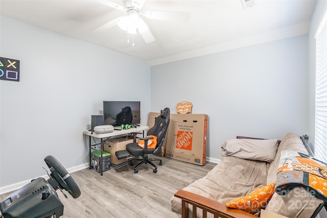 office area with a ceiling fan, baseboards, and wood finished floors