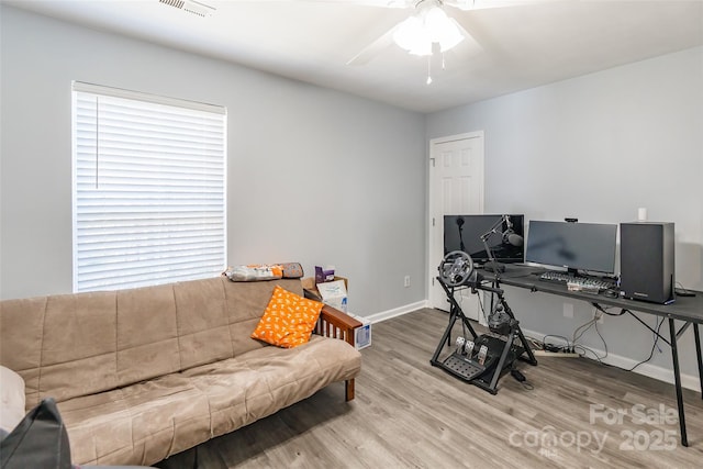 office with a ceiling fan, baseboards, and wood finished floors