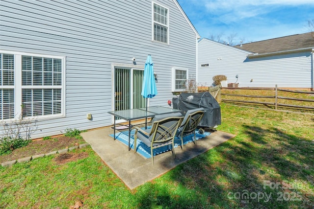 rear view of property with a yard, fence, and a patio