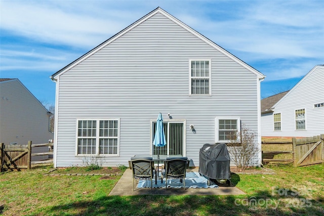 back of property featuring a patio area, a yard, and a fenced backyard