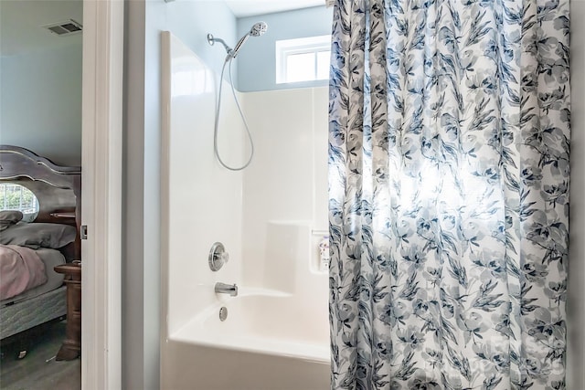 ensuite bathroom with shower / tub combo with curtain, visible vents, and connected bathroom