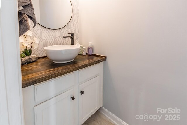 bathroom featuring vanity and baseboards