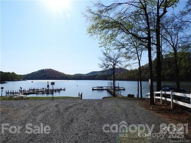 view of dock featuring a water and mountain view