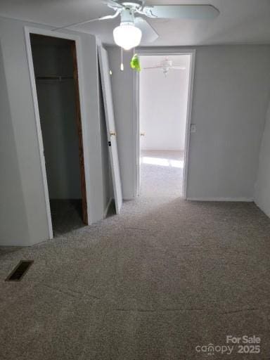 unfurnished bedroom with a ceiling fan, a closet, visible vents, and carpet flooring