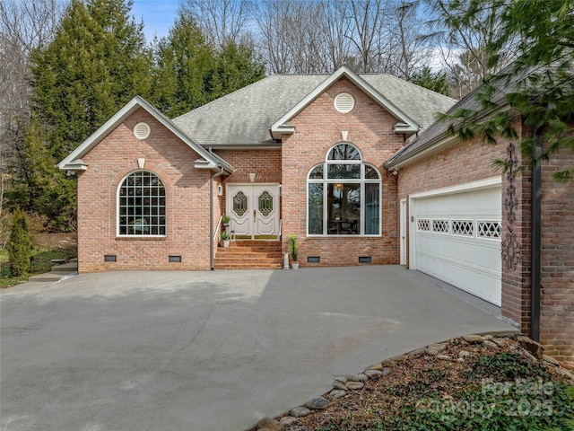 view of front of home with driveway, brick siding, crawl space, and roof with shingles