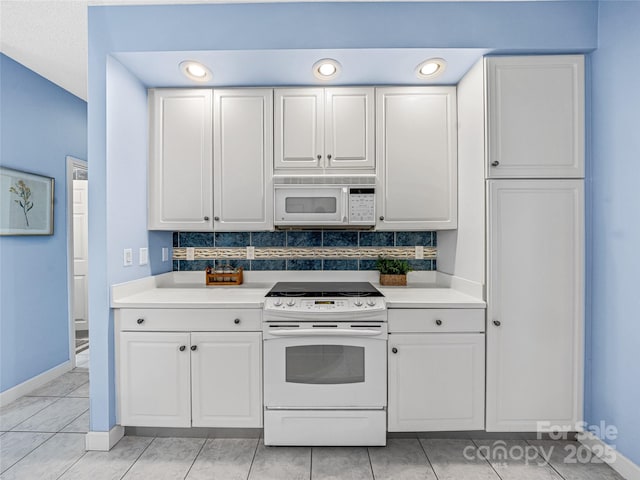 kitchen featuring white appliances, light countertops, backsplash, and white cabinets