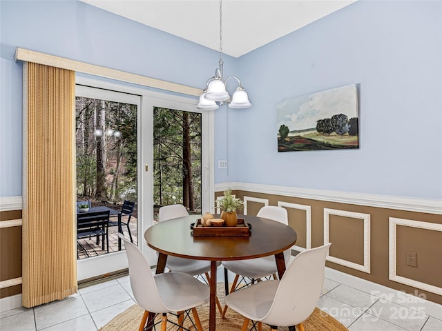 tiled dining area featuring an inviting chandelier