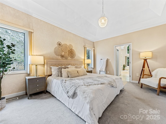 bedroom with light colored carpet, visible vents, baseboards, a raised ceiling, and crown molding