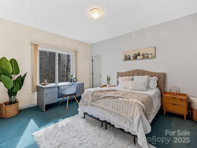 bedroom with dark colored carpet, a textured ceiling, and baseboards