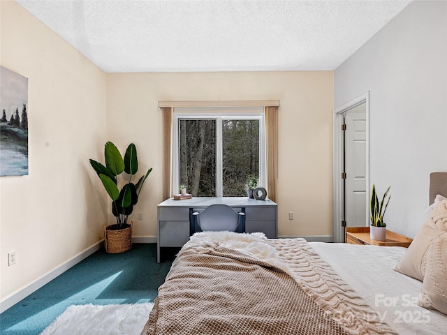 bedroom with dark colored carpet, a textured ceiling, and baseboards