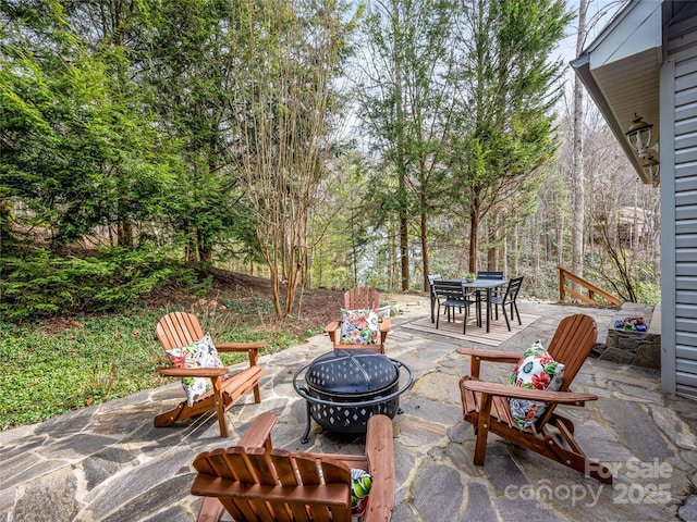 view of patio / terrace with an outdoor fire pit and outdoor dining space