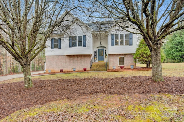 bi-level home featuring brick siding