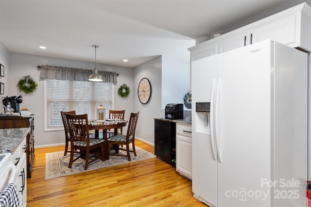 dining room with baseboards, recessed lighting, and light wood-style floors