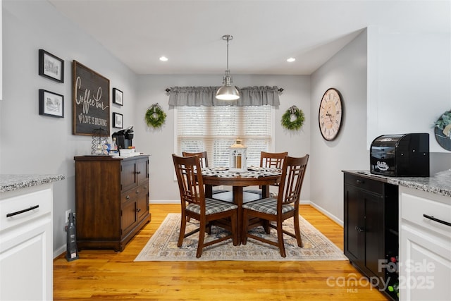 dining space with recessed lighting, light wood-style flooring, and baseboards