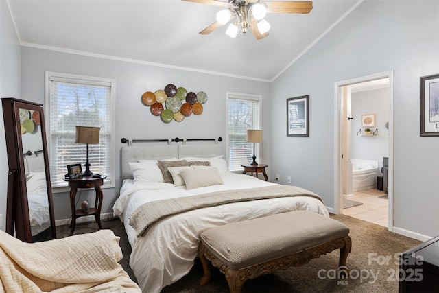 bedroom with light carpet, baseboards, ensuite bath, ornamental molding, and vaulted ceiling