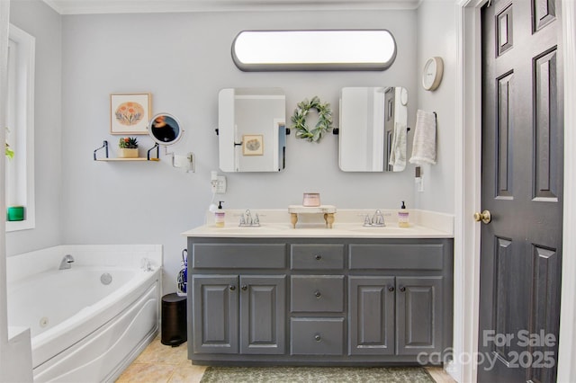 full bathroom with double vanity, a tub with jets, a sink, and tile patterned floors