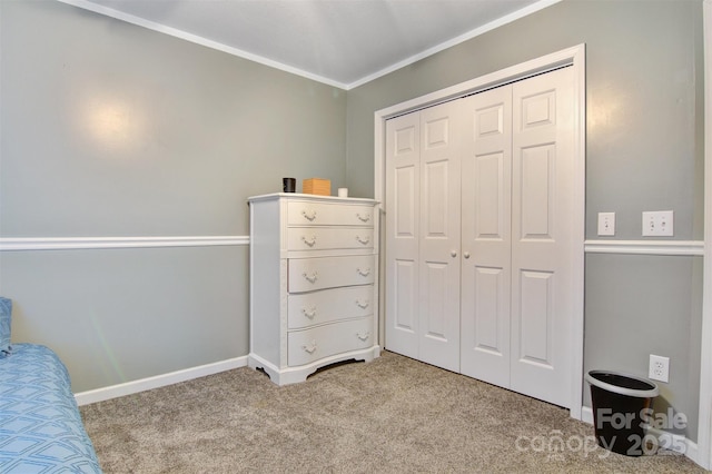 bedroom with a closet, baseboards, crown molding, and light colored carpet