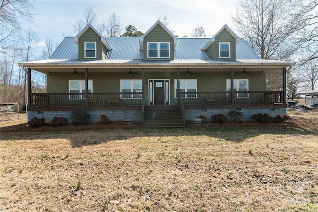 farmhouse-style home featuring covered porch, a ceiling fan, a front yard, crawl space, and metal roof