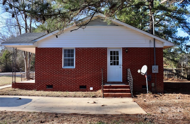 bungalow-style home featuring entry steps and brick siding