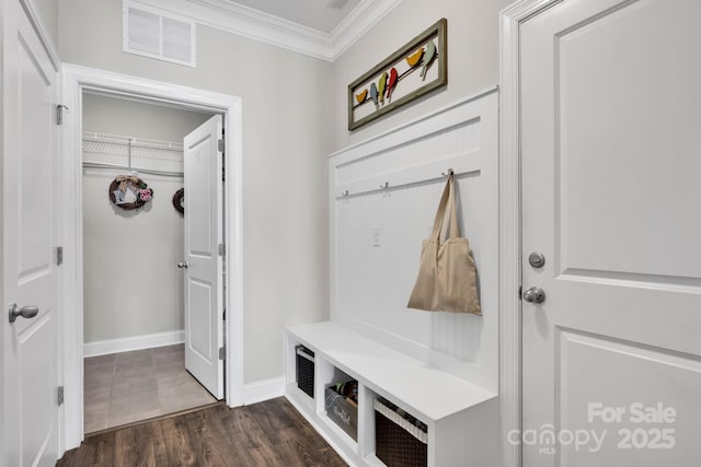 mudroom featuring baseboards, dark wood-style flooring, visible vents, and crown molding