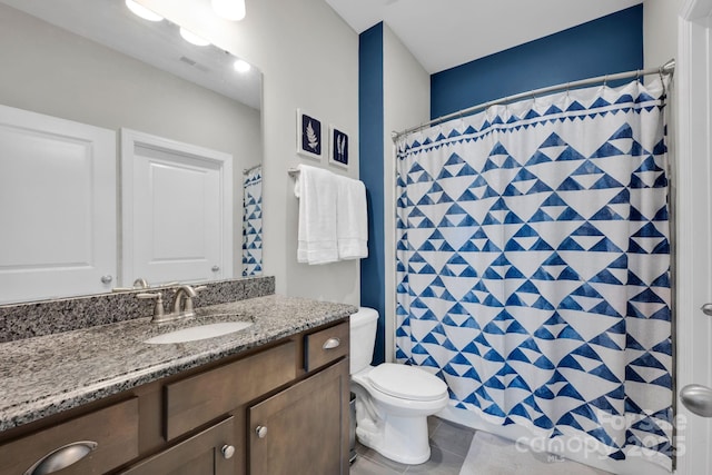 bathroom featuring curtained shower, visible vents, toilet, vanity, and tile patterned floors