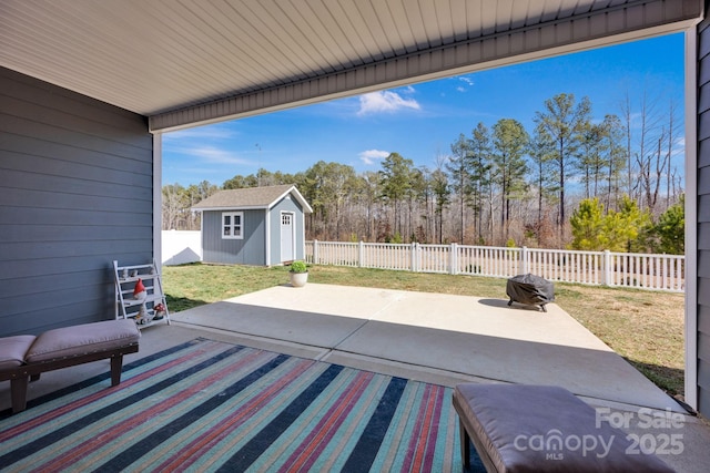 view of patio featuring a fenced backyard, an outdoor structure, and a shed