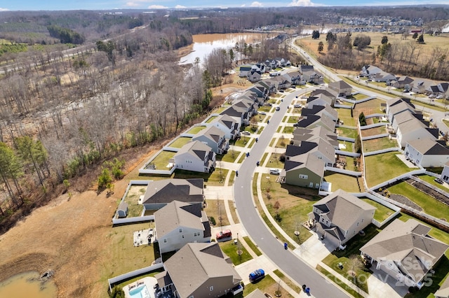 birds eye view of property with a water view and a residential view