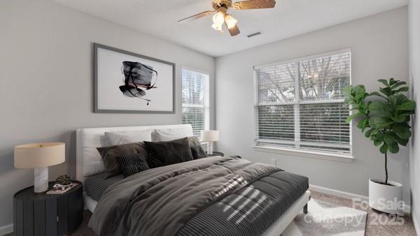 carpeted bedroom featuring visible vents, ceiling fan, and baseboards