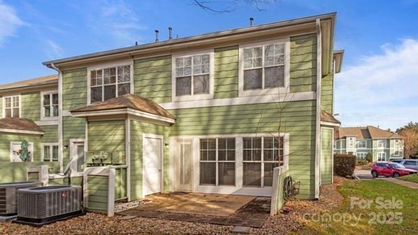 rear view of house with central AC unit