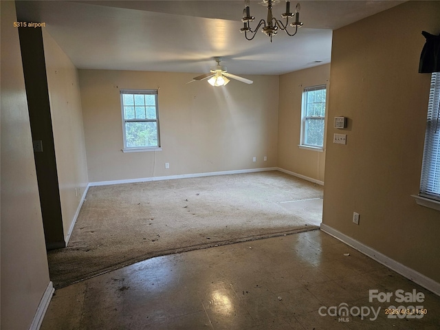 5315 Airport Dr, Charlotte, NC 28208 - unfurnished room featuring ceiling fan with notable chandelier, baseboards, and a wealth of natural light
