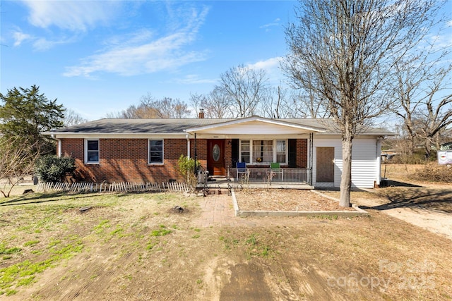 ranch-style home featuring a porch and brick siding