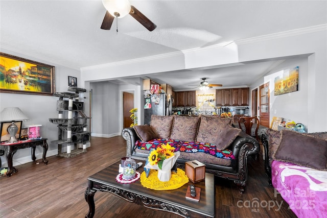 living room with ceiling fan, baseboards, crown molding, and wood finished floors