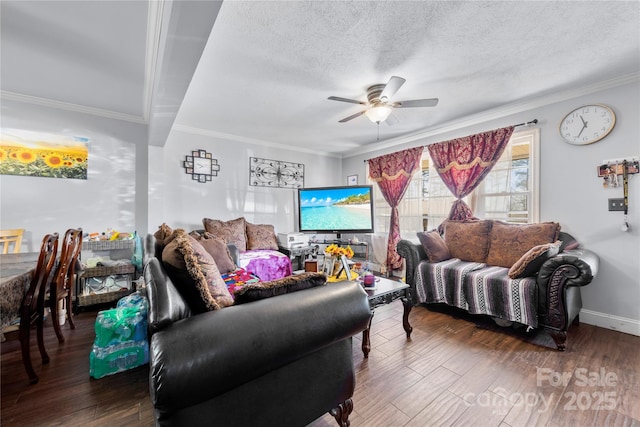 living area with baseboards, ceiling fan, ornamental molding, wood finished floors, and a textured ceiling