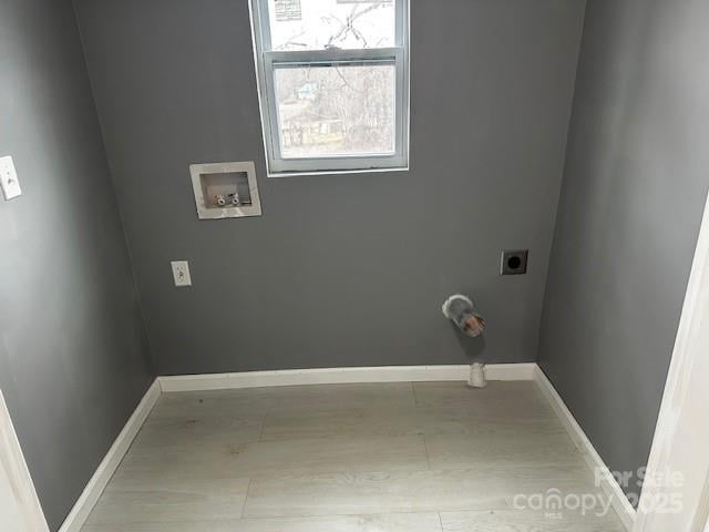 clothes washing area featuring laundry area, baseboards, wood finished floors, hookup for an electric dryer, and washer hookup