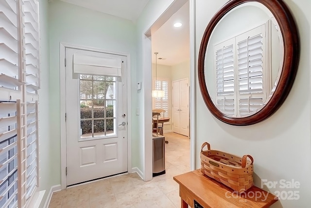 entryway with recessed lighting, light tile patterned flooring, and baseboards