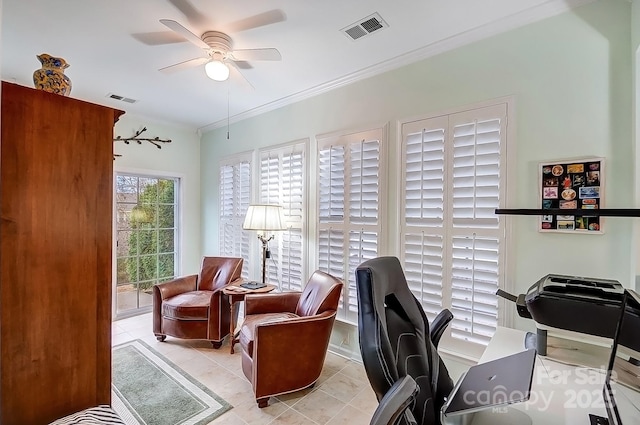 home office with tile patterned floors, ceiling fan, visible vents, and ornamental molding